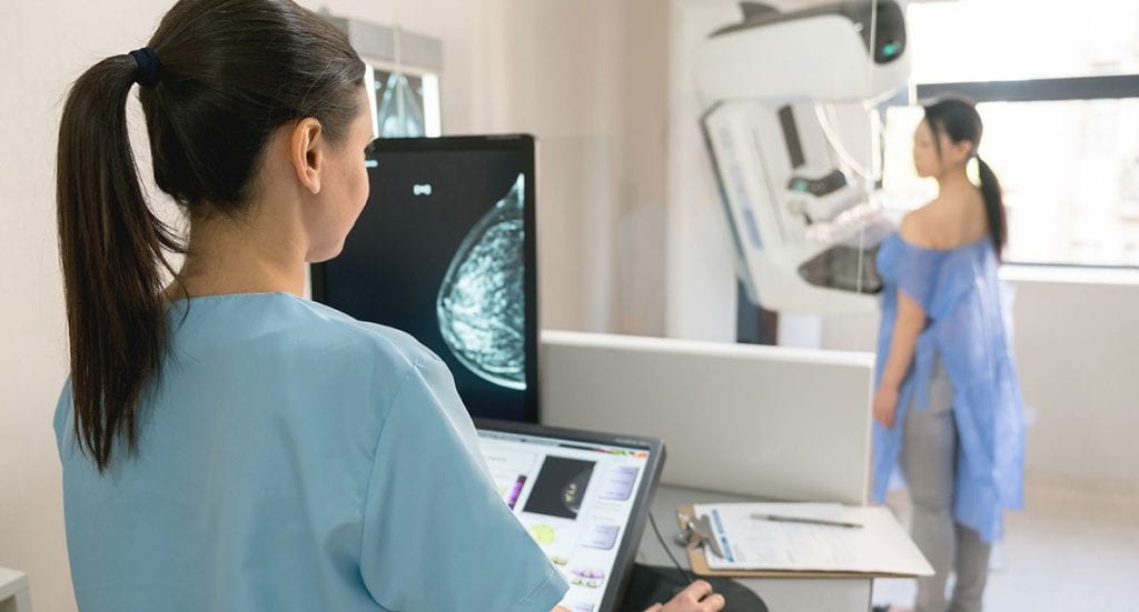 a woman being screened for mammogram